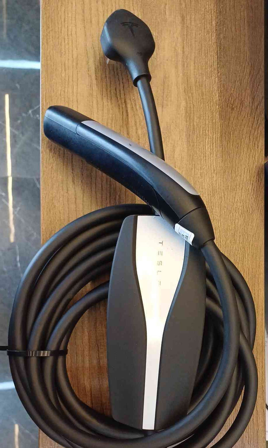 Tesla Universal Mobile Connector US (NACS) 1937825-00-C - photo, mobile connector with NACS handle and the cable coiled around the unit - Original / US (NACS)